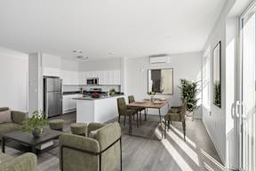 A modern kitchen with a dining table and chairs.