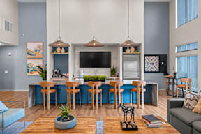 A modern kitchen and dining area with a blue accent wall.