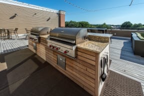 Grills on community roof deck | The Merc at Moody and Main