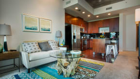a living room with a white couch and a glass coffee table