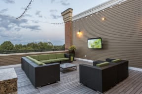 Rooftop patio with seating and outdoor televisions