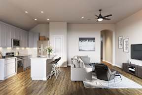 A modern living room with a kitchen area in the background at Walker Place Apartments, Texas