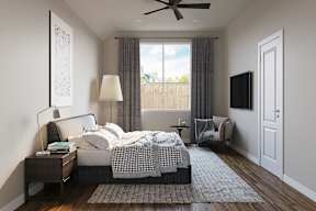 A bedroom with a large bed and a ceiling fan at Walker Place Apartments, Hewitt, TX