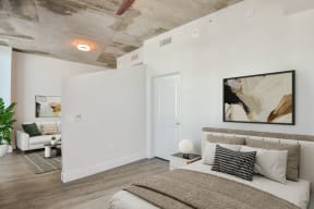 a bedroom with a bed and a couch in a 555 waverly unit