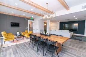 a conference room with a long wooden table and black chairs