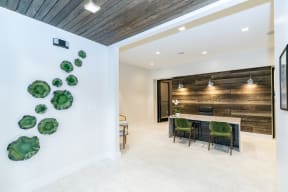 a dining room with a long table and green chairs