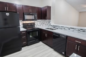 Kitchen with black appliance package | Gateway Club