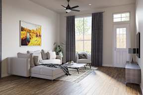 A living room with a large couch, a painting on the wall at Walker Place Apartments, Hewitt