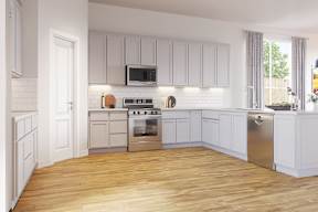 A kitchen with white cabinets and a wooden floor at Walker Place Apartments, Hewitt, TX