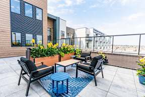 A patio with a table and chairs overlooking a building at Vista Apartments at Edgemont, Edmonton, AB
