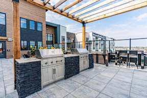 A patio with a grill and a table at Vista Apartments at Edgemont, Edmonton, AB