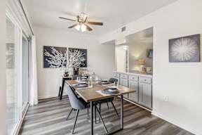 a dining room with a table and a ceiling fan at Oaks at Oxon Hill, Oxon Hill, Maryland