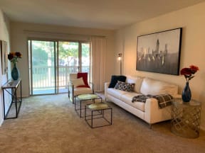 a living room with a white couch and a sliding glass door