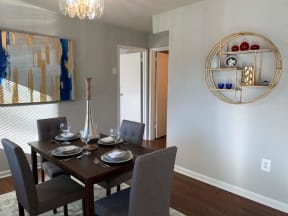a dining room with a table and chairs