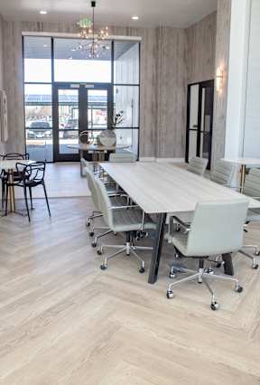 Conference room with a wooden table and white chairs