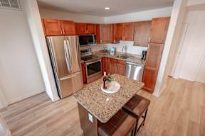 A kitchen with wooden cabinets and stainless steel appliances.