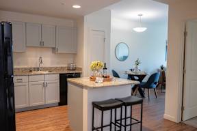 A kitchen with a bar area and a dining table.