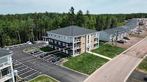 A large building with a parking lot in front of it.