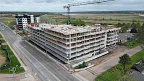 A large building under construction with a crane in the background.