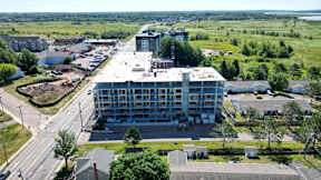 A large building with a parking lot in front of it.