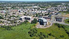 A bird's eye view of a city with a large building in the center.