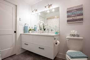 a bathroom with a toilet and a sink and a mirror