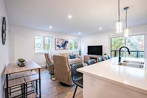a living room with a kitchen and a dining table