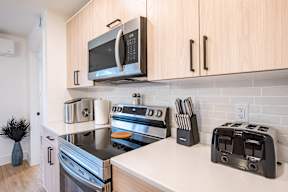 a kitchen with stainless steel appliances and a microwave