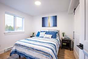 a bedroom with a bed and a window