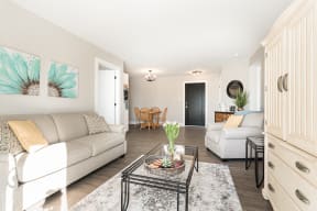a living room with two couches and a glass table