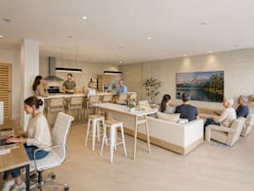 A group of people are gathered in a modern living room.