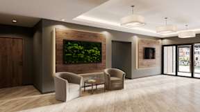 A modern office lobby with a green wall and a wooden floor.