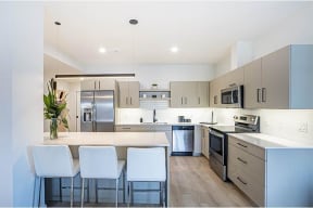 a large kitchen with a table and chairs