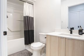 a white bathroom with a toilet and a sink