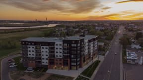 an aerial view of a building in a city at sunset