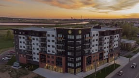 an aerial view of an apartment building at sunset