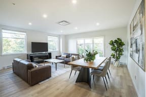 a living room with couches a table and a television