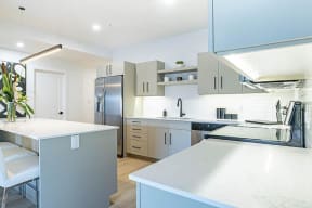 a large white kitchen with stainless steel appliances