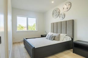 a bedroom with a bed and some plates on the wall