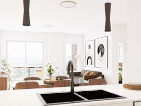 A modern kitchen with a large island and a view of the city.