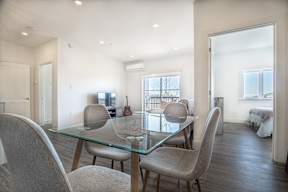 a dining room with a glass table and chairs