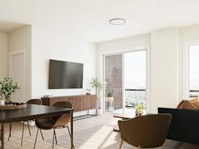 A modern living room with a flat screen TV mounted on the wall.