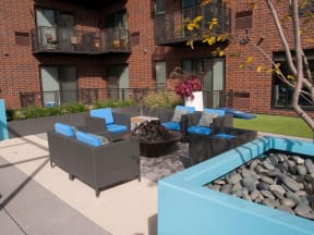 Outdoor community fire pit with 5 lounge chairs surrounding