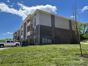an apartment building with a truck parked in front of it