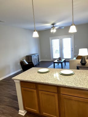 an empty living room with an island in the middle