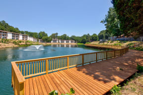 a deck overlooking a lake with a fountain