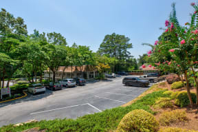 a parking lot with cars parked in front of a building