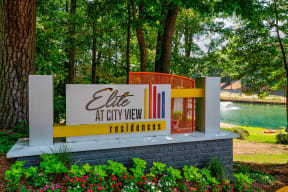 a sign for life at city view with a lake and trees