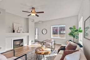 a living room with a couch and a ceiling fan at The Residences Apartments at Bear Tree, DeForest, WI