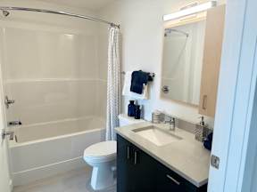 A white toilet sits next to a sink in a bathroom.